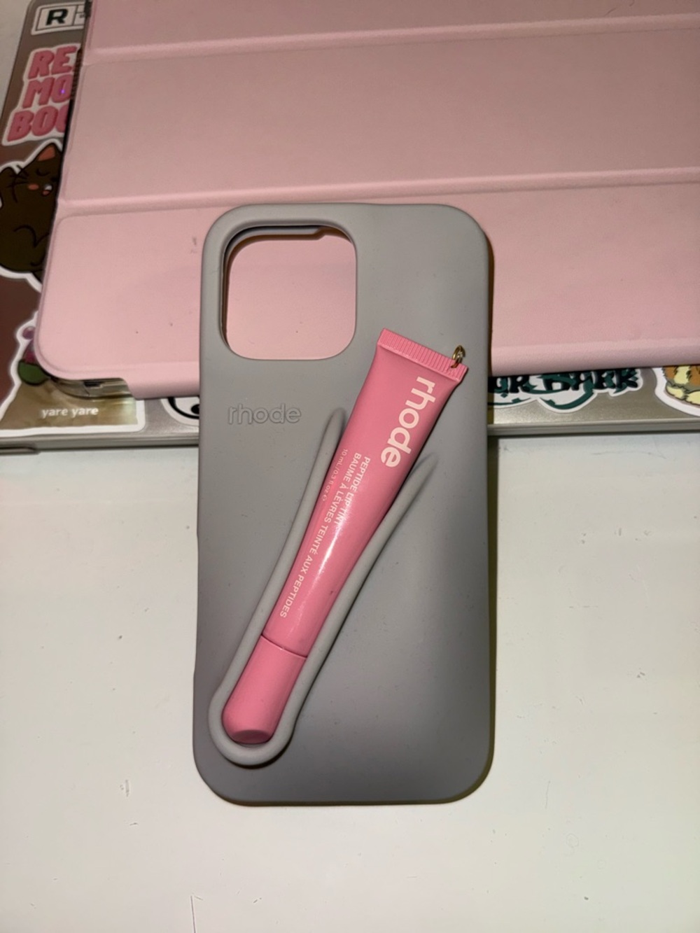 RHODE Pink Lip Balm Tube with Gray Silicone Phone Case